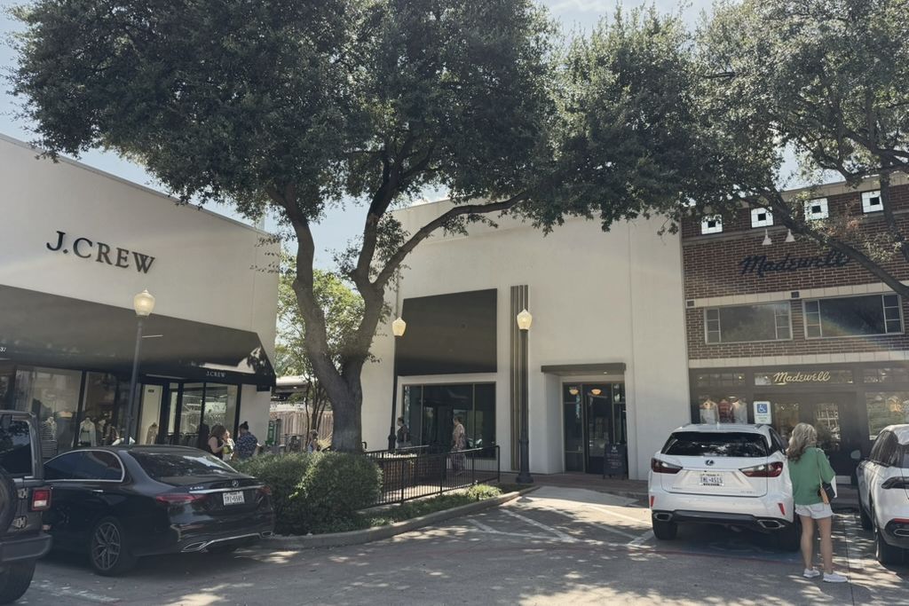 The Manor Aesthetics & Wellness frontage at University Park Village in Fort Worth, between the J.Crew and Madewell storefronts, with surface parking immediately outside