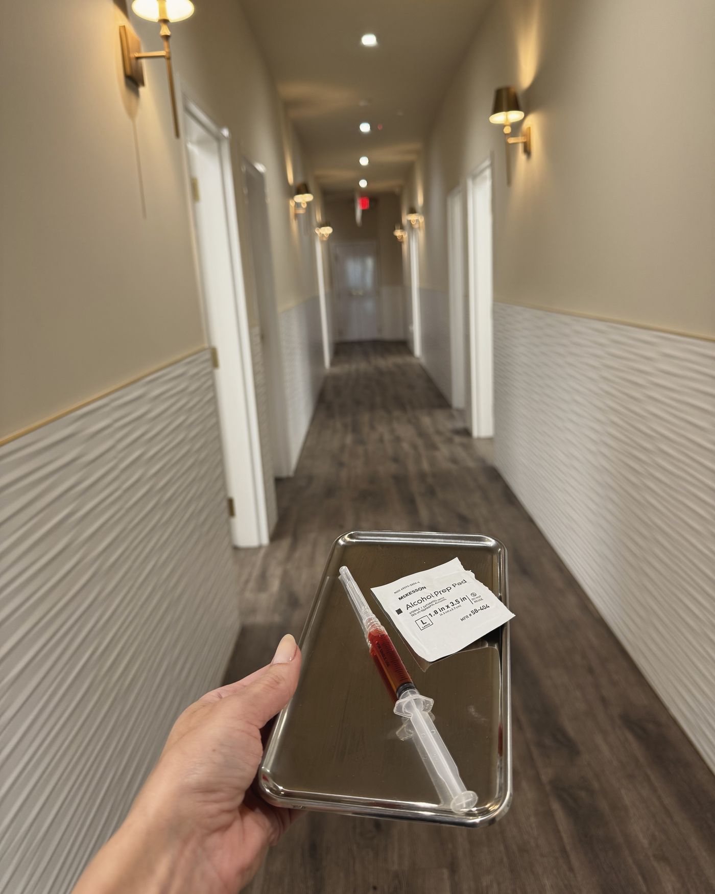 A prepared tray carried along the treatment corridor at Manor Aesthetics & Wellness in Fort Worth